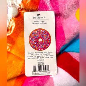 Brand new (in original packaging) 5’ round donut beach towel w ball fringe.